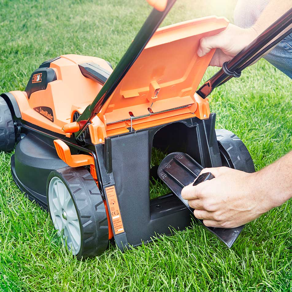 Inserting mulch plug into LawnMaster 24V cordless lawnmower