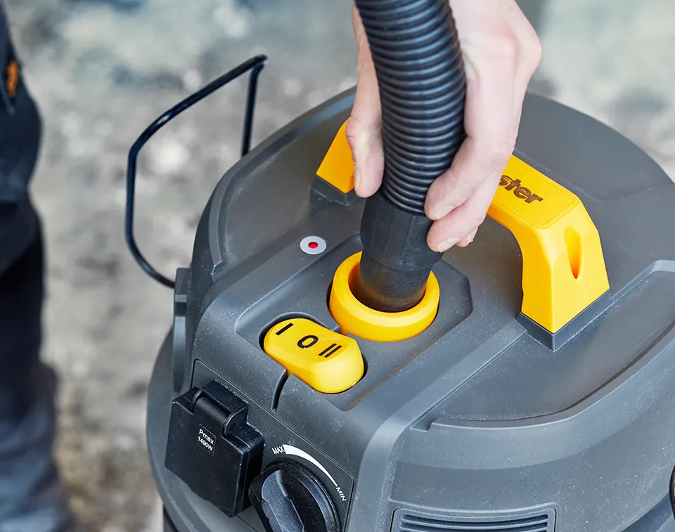 dust extractor vacuum cleaner being cleaned with push clean filter system