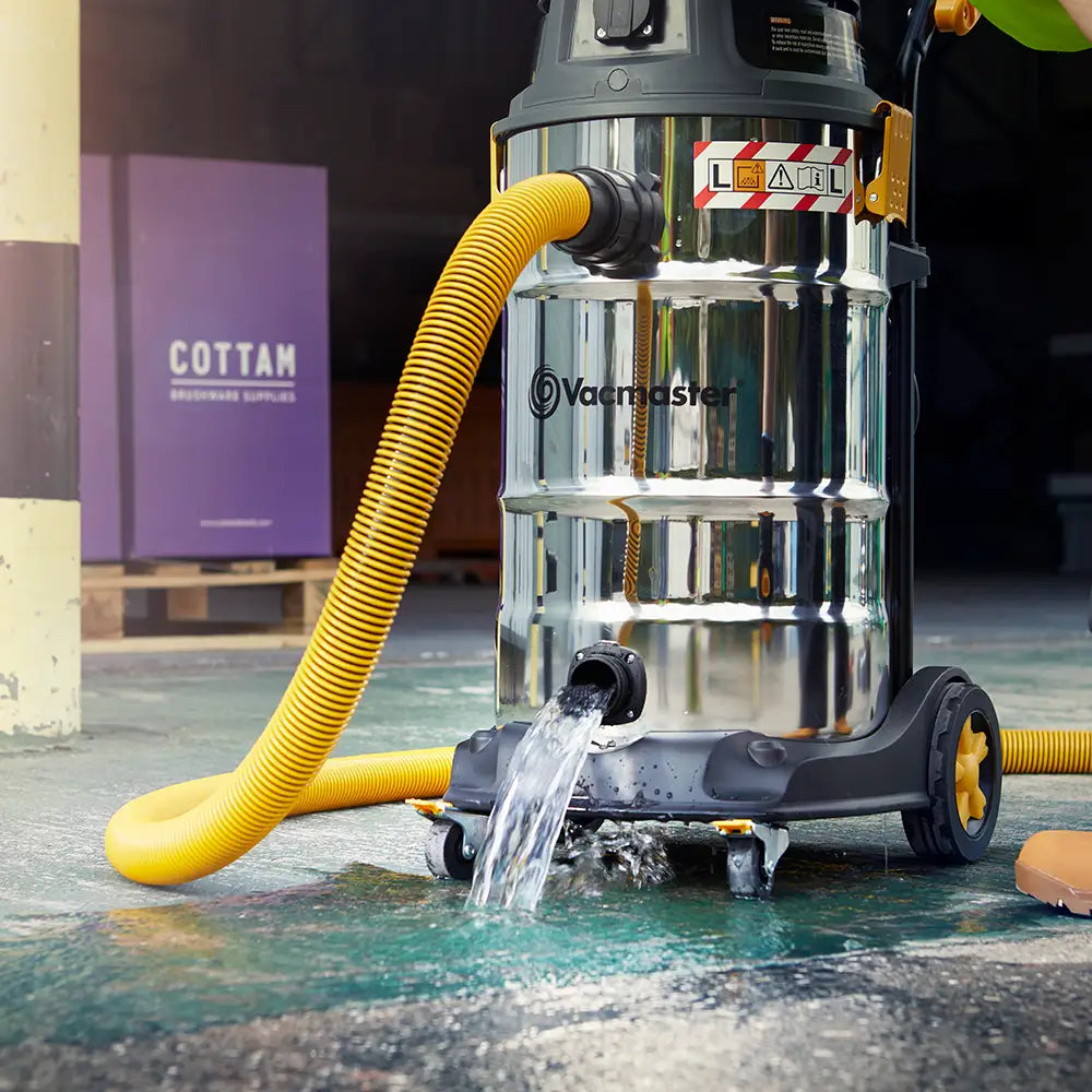 Vacmaster wet and dray vacuum cleaner draining water from large tank with drainage plug