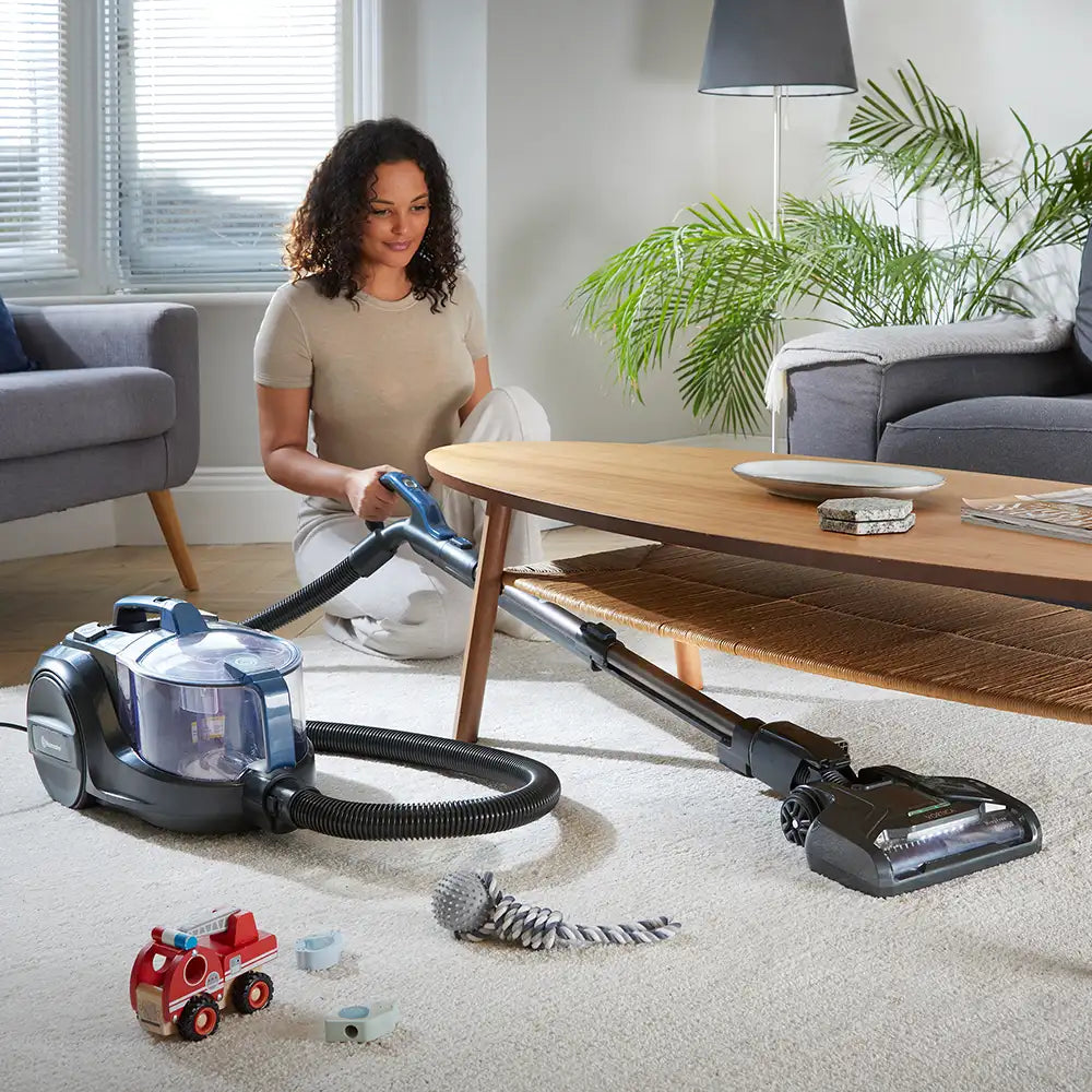 Vacmaster Vortica Cylinder Vacuum Cleaner vacuuming under a table CC0201EHUK 