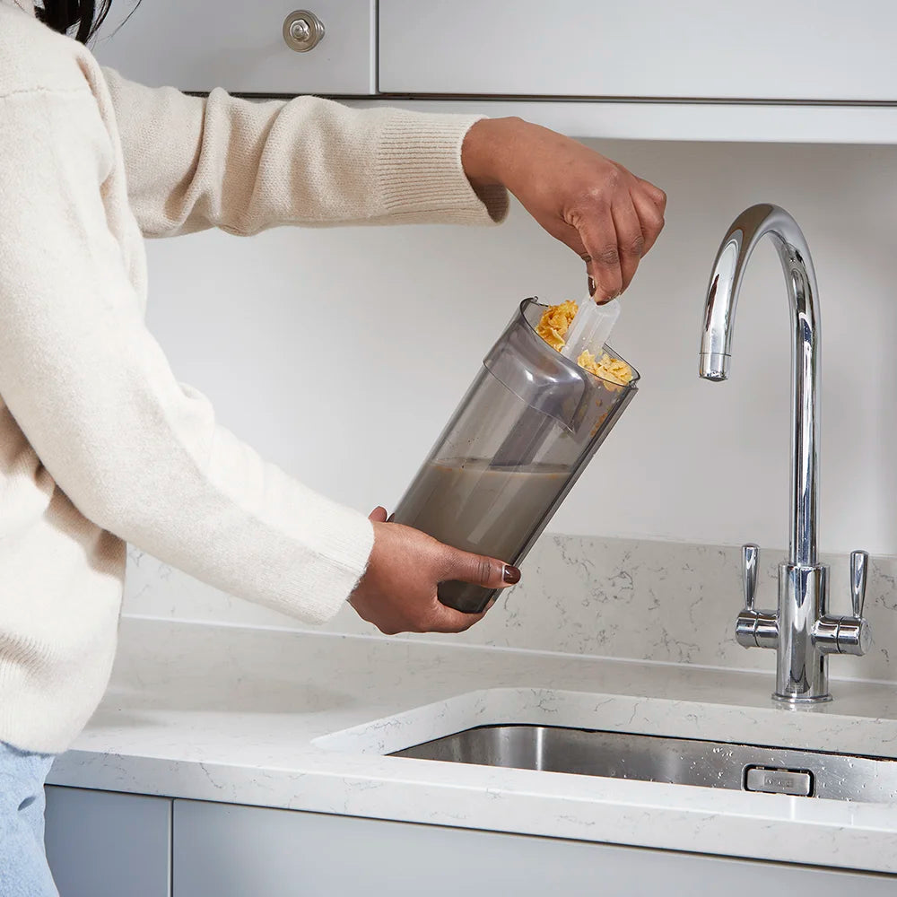 Vacmaster Hard Floor Cleaner HVA strainer being removed over kitchen sink HA2203UK