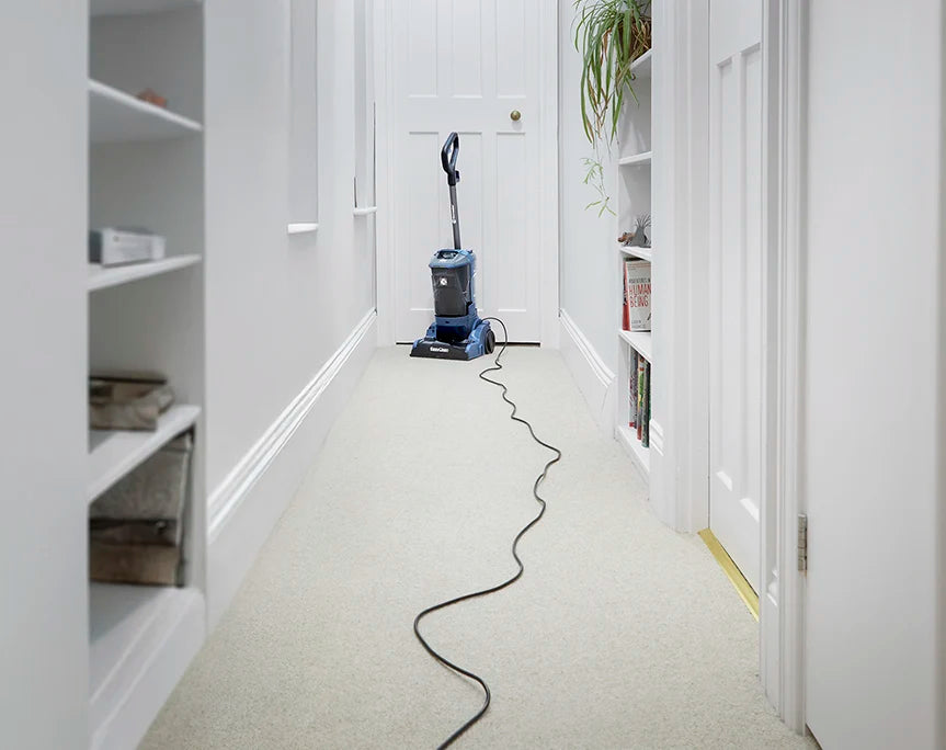 Long Reach Cable Vacmaster UCT Carpet Cleaner at the End of a Long Hallway in a Home