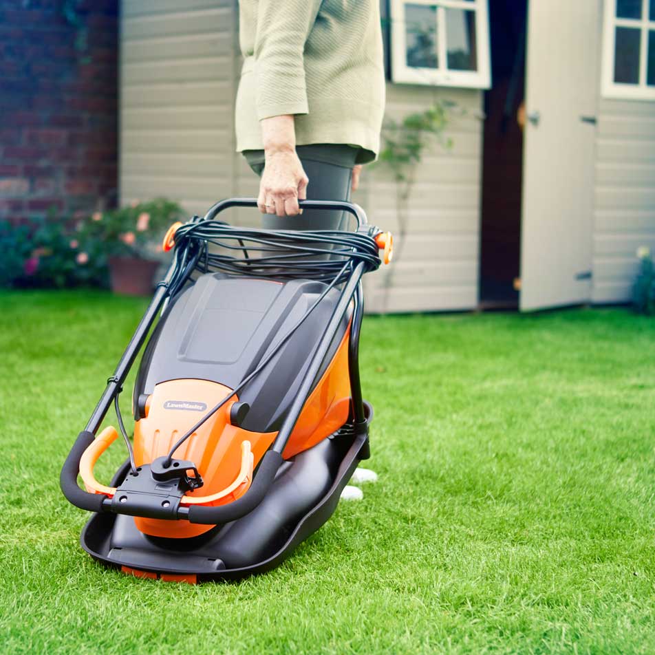 LawnMaster Hover Collect Mower 36cm 1800W being wheeled across the lawn