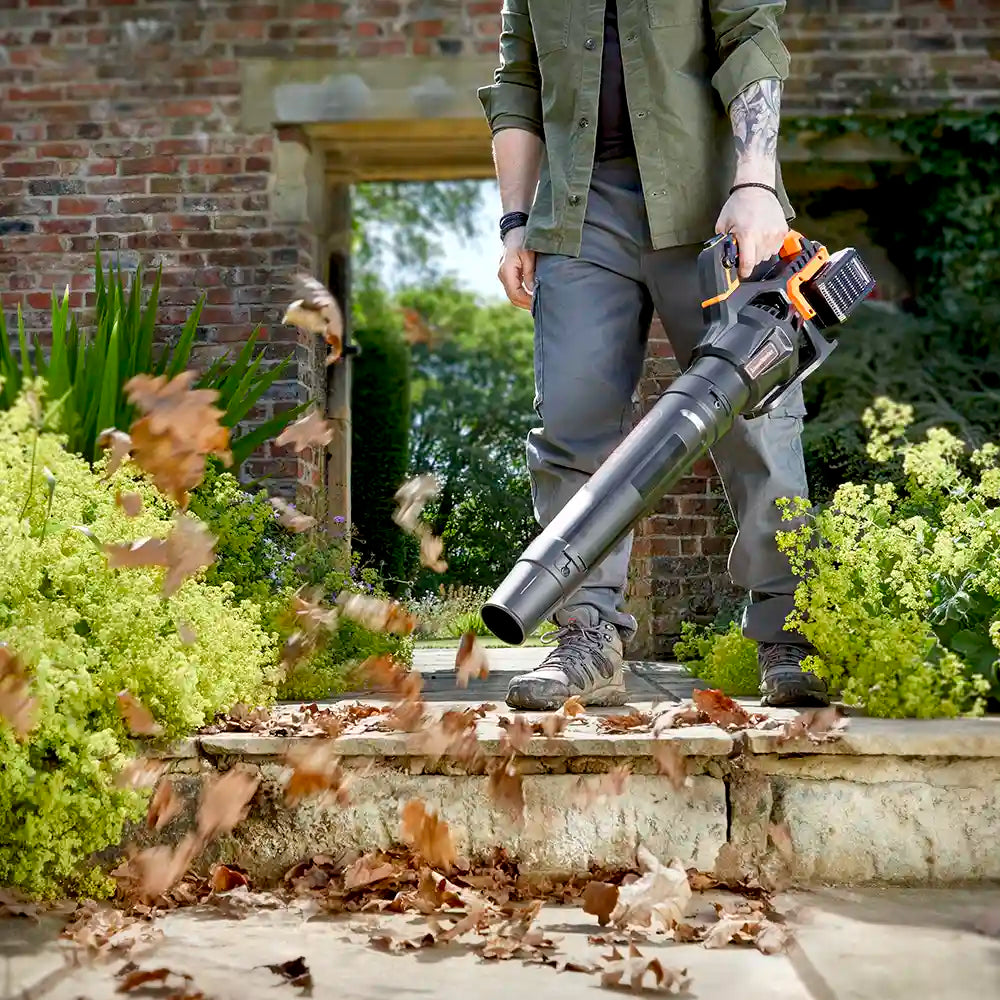 LawnMaster 8V Axial leaf blower moving leaves on garden path