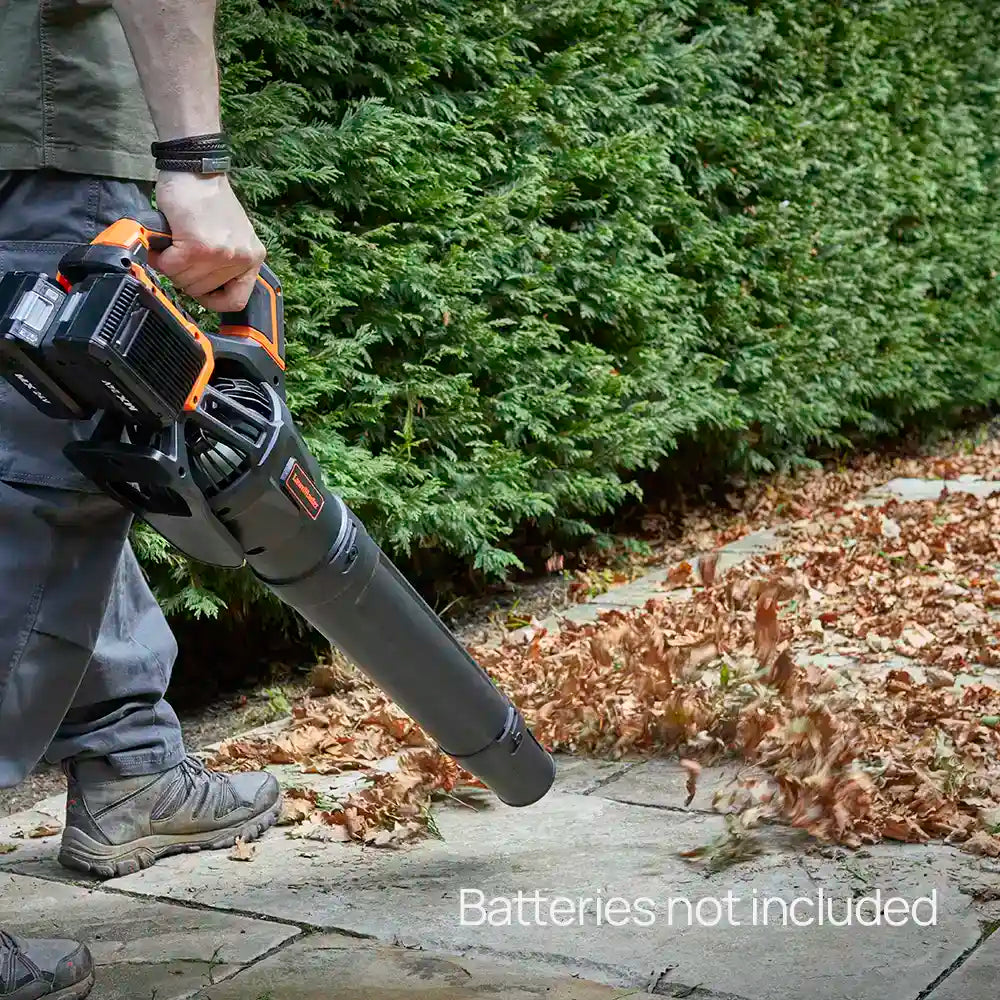 Man blowing leaves across path with LawnMaster Axial leaf blower