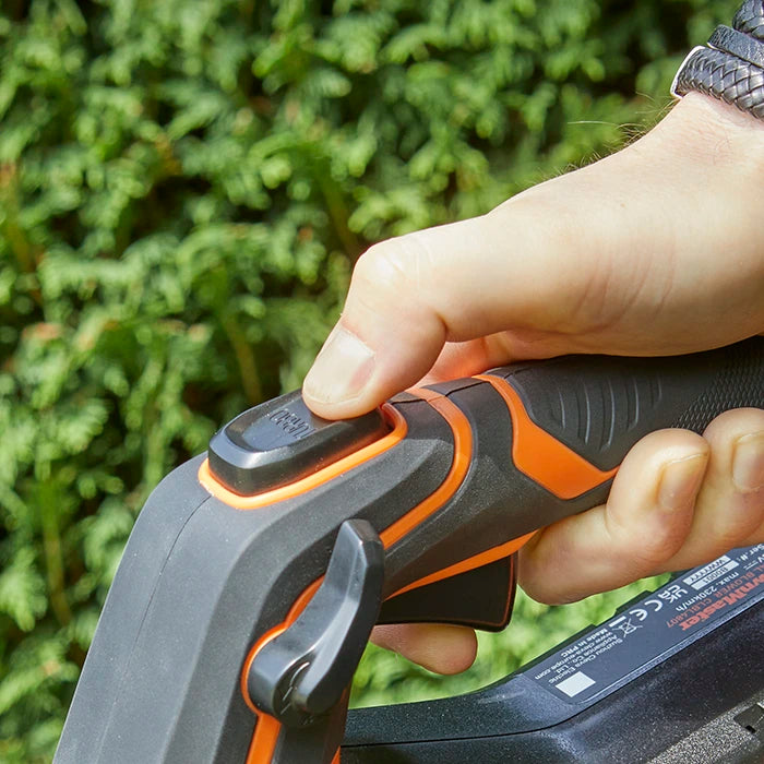 Man pressing turbo button on LawnMaster 48V Axial leaf blower