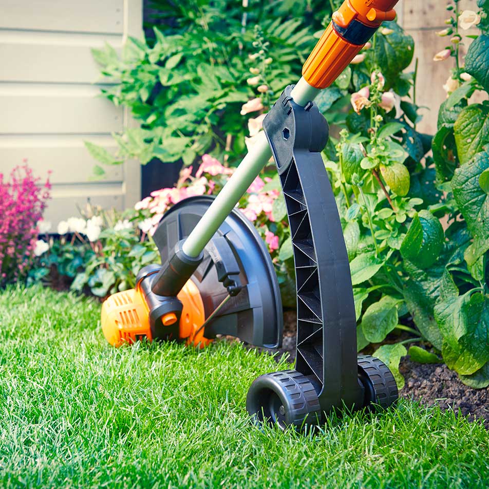 LawnMaster 24V Grass Strimmer in edging mode with optional wheel kit