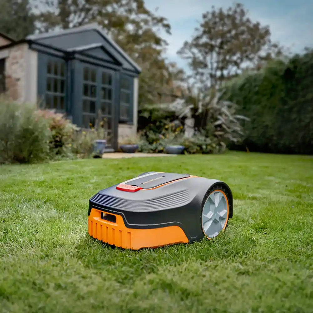 LawnMaster L10 robot lawn mower cutting grass in a Irish garden